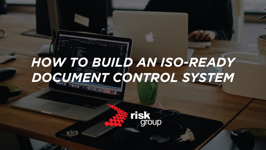 A banner image designed to promote Risk Group's free guide. The background image shows colleagues collaborating around a boardroom table. A text overlay reads: "How to Build an ISO-Ready Document Control System".
