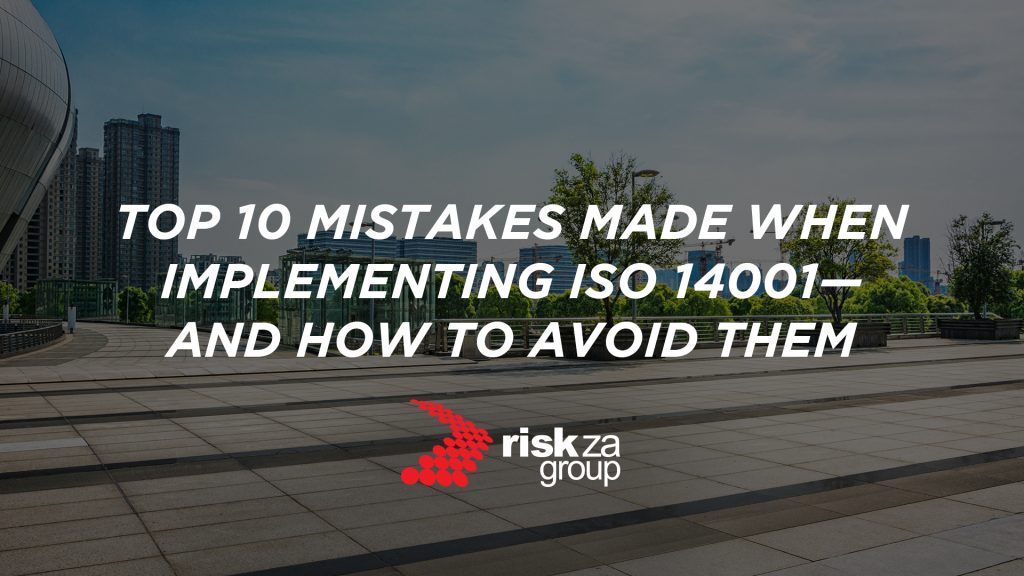 A banner designed specifically for the Risk ZA Group brand. The background image shows a modern city with visible green initiatives like eco-friendly buildings, rooftop gardens, or renewable energy installations, symbolizing the integration of sustainability into urban and business settings. There is a text overlay that reads: "Top 10 Mistakes Made When Implementing ISO 14001". The Risk ZA Group is included.