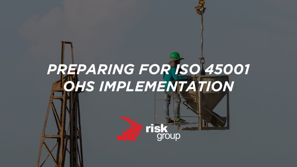 A banner image designed to promote Risk Group's free guide. The background image shows a construction site. A text overlay reads: "Preparing for ISO 45001 OHS Implementation".